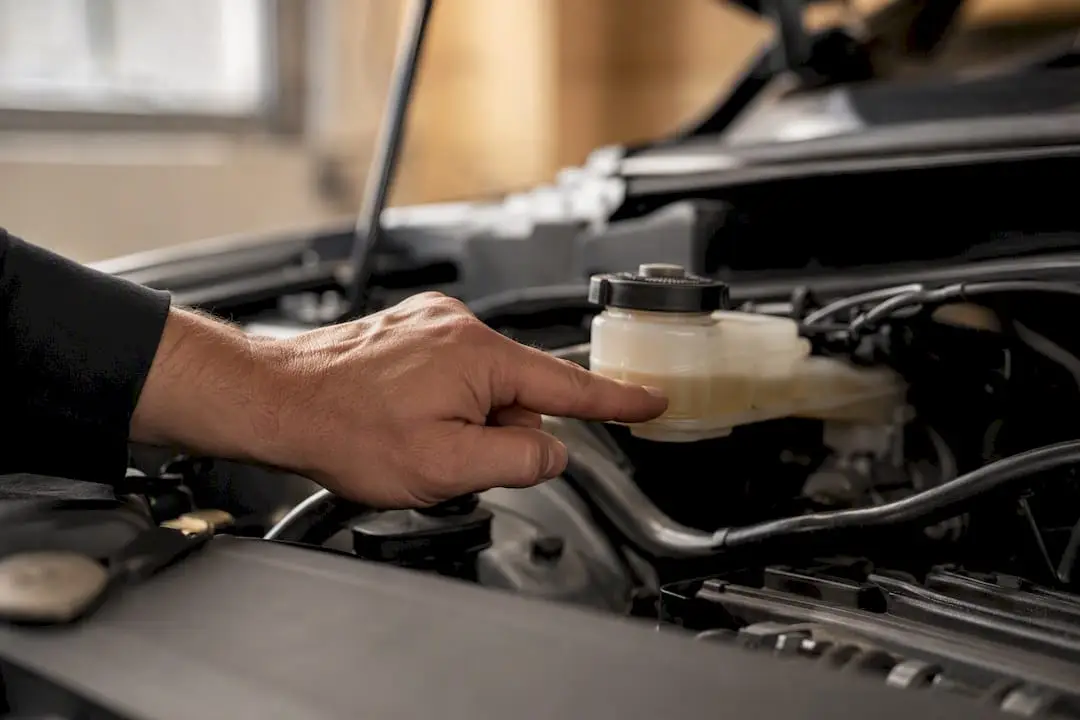 Hand checking brake fluid reservoir level