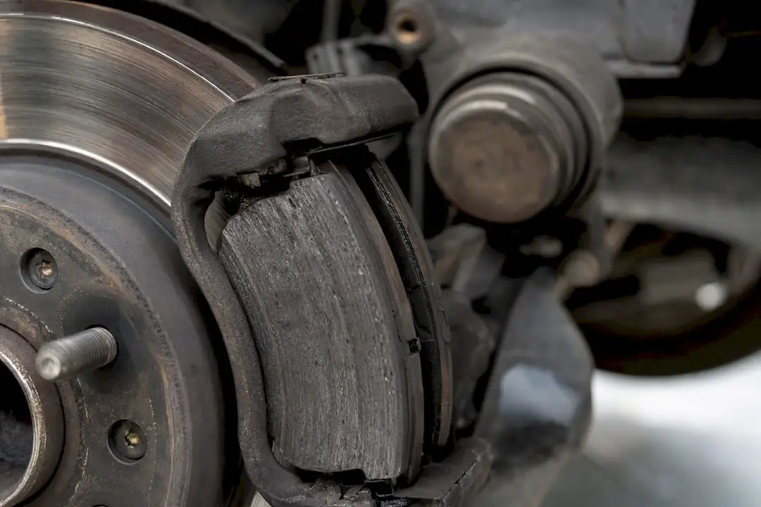 Close-up worn brake pads and rotor
