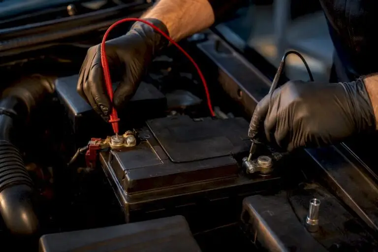 Technician testing battery voltage connections