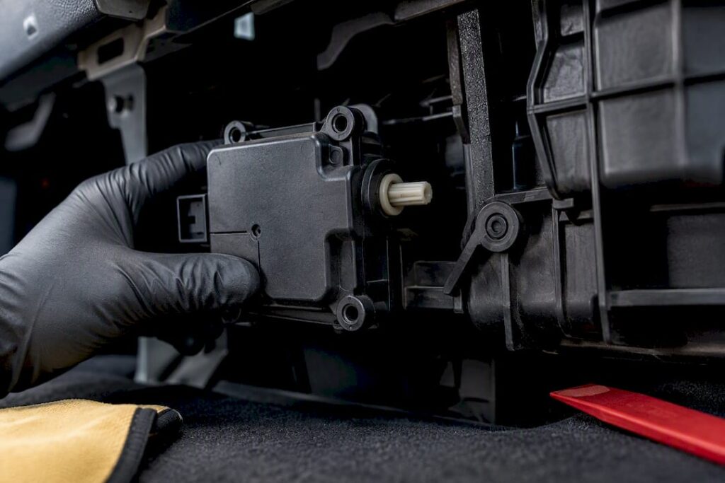 Technician inspecting blend door actuator